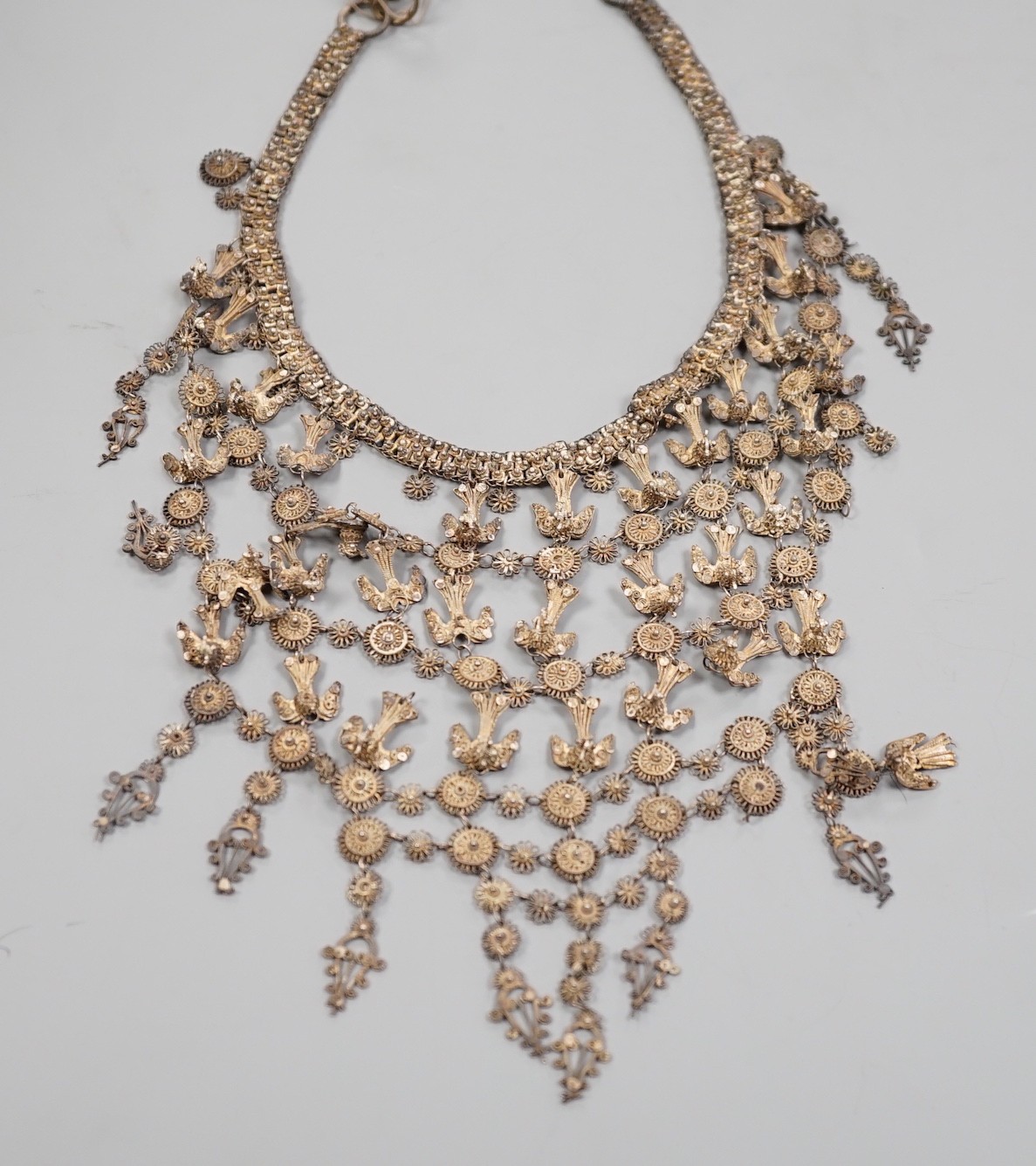 An Indian white metal (tests as 900 standard) filigree fringe necklace, decorated with peacocks, approx. 72cm.